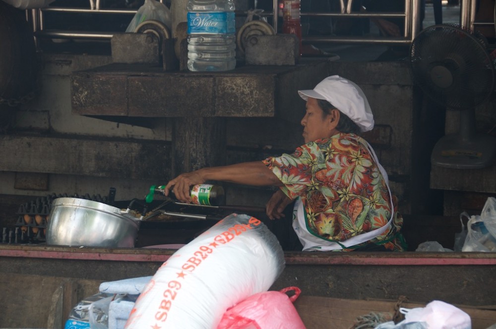 Lady cooking at Taling Chan Floating Marketing, Bangkok