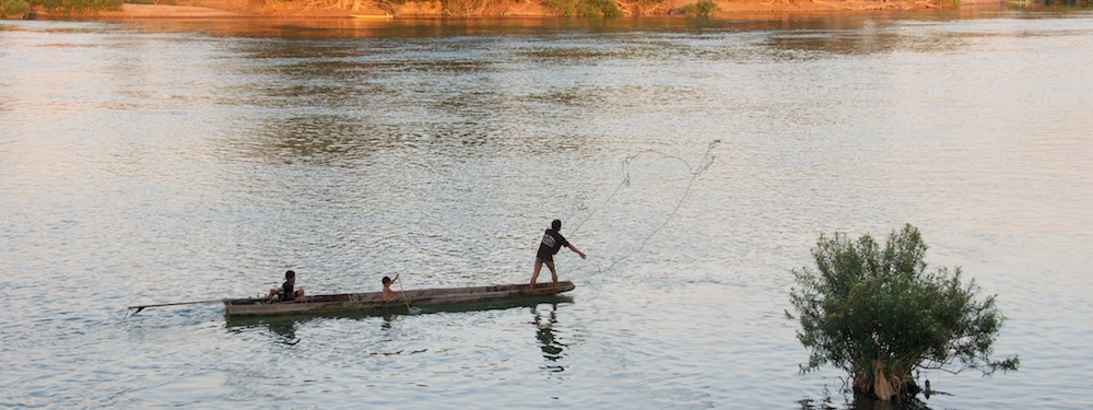 Fisherman throwing net on Mekong